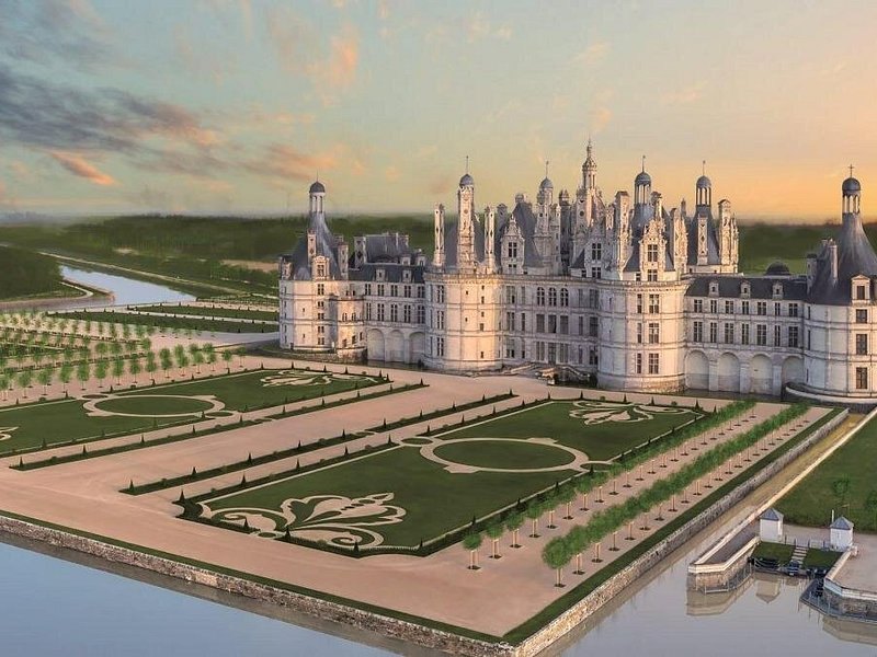 Chambord and its French formal gardens seen from above in low evening light