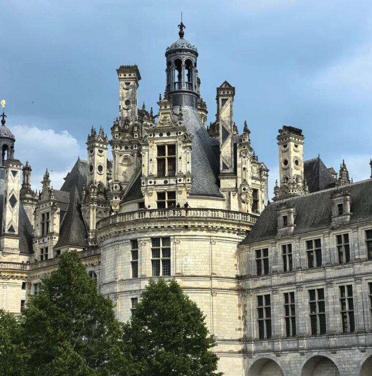 Chambord Castle rooftop terrace with chimneys, turrets and dormers